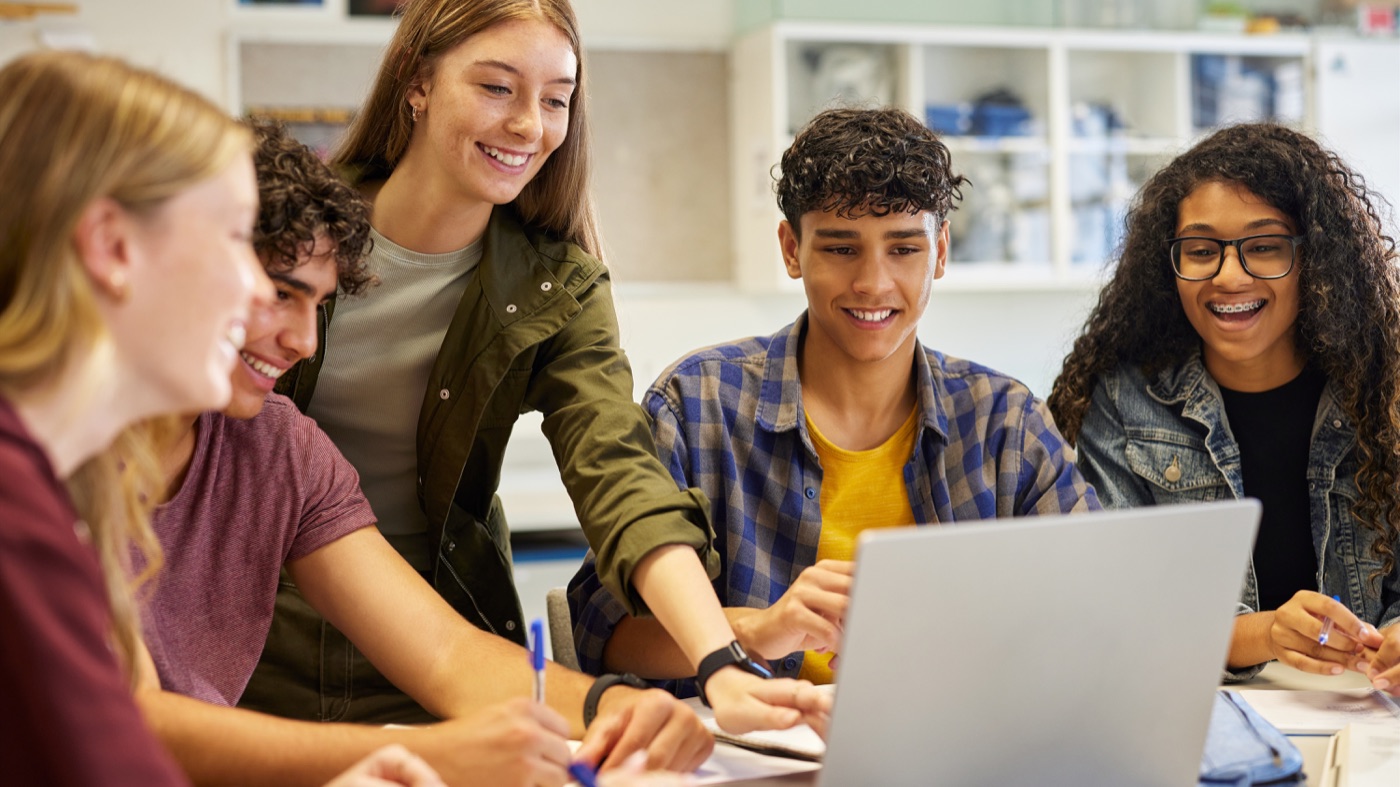 International students studying together with a laptop