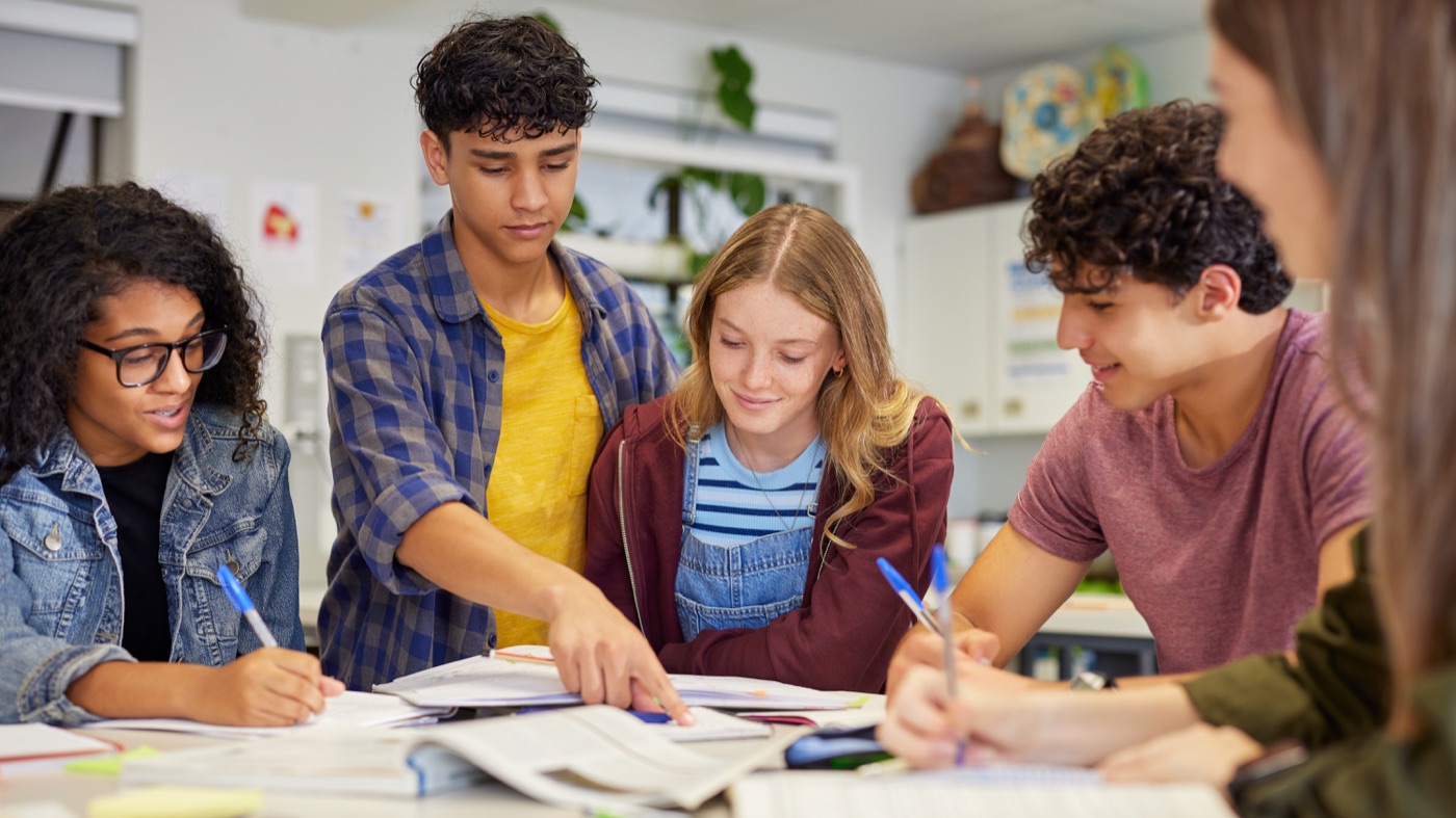 International students studying together with a laptop